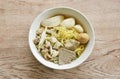 boiled Chinese yellow egg noodles with entrails and fish ball in soup on bowl Royalty Free Stock Photo