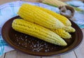 Boiled cobs of sweet corn on a clay plate. Royalty Free Stock Photo