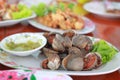 Boiled Cockles with spicy seafood sauce in white dish Royalty Free Stock Photo