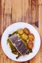 Boiled cod fish with potato and greens on white plate Royalty Free Stock Photo