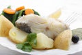 Boiled cod fish with potatoes and cole