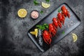 Boiled cooked crayfish crawfish with lemon and herbs on a slate plate ready to eat on black background. banner, menu, recipe place Royalty Free Stock Photo