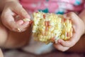 Boiled corn in the babies hands