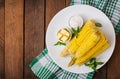 Boiled corn with salt and butter on a white plate. Royalty Free Stock Photo