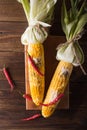 Boiled corn with salt, parmesan, herbs, chili peppers