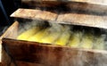 Boiled corn in a wooden crate with smoke