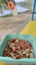 Boiled crabs in a bowl on the beach by the lake. Rest in nature