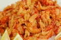 boiled craw fish meat on the plate with lemon slices, Japanese sticks, salad and straw mat closeup photo