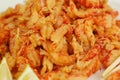 boiled craw fish meat on the plate with lemon slices, Japanese sticks, salad and straw mat closeup photo