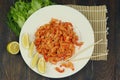 boiled craw fish meat on the plate with lemon slices, Japanese sticks, salad and straw mat closeup photo