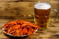 Boiled crayfish and mug of beer on wooden table Royalty Free Stock Photo