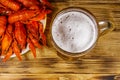 Boiled crayfish and mug of beer on wooden table Royalty Free Stock Photo