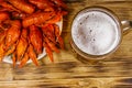 Boiled crayfish and mug of beer on wooden table Royalty Free Stock Photo