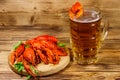 Boiled crayfish and mug of beer on wooden table Royalty Free Stock Photo