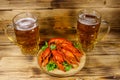 Boiled crayfish and two mugs of beer on wooden table Royalty Free Stock Photo