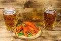 Boiled crayfish and two mugs of beer on wooden table Royalty Free Stock Photo