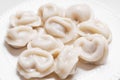 Boiled dumplings are arranged in a circle on a white plate. Royalty Free Stock Photo