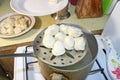 Boiled dumplings are pulled out of the pan with a skimmer