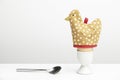Boiled egg in cup with hen egg warmer and spoon Royalty Free Stock Photo