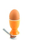 A boiled egg in cup with spoon