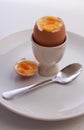 Boiled egg,cut open in eggcup,on plate with spoon