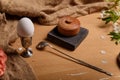 Boiled egg in egg cup, silver spoon, salt pot and cherry blossom on sackcloth and wooden brown background. Spring and Easter Royalty Free Stock Photo