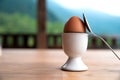 Boiled egg in eggcup on wooden table outside, breakfast eggin white egg cup Royalty Free Stock Photo