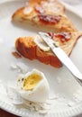 Boiled egg partially peeled with toast