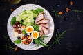 Boiled egg, pork steak and olives, cucumber, spinach, brie cheese, nuts and blueberry Royalty Free Stock Photo