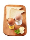 Boiled eggs in eggcups and white bread