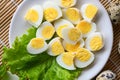 boiled eggs food, quail eggs on white plate, breakfast eggs with fresh quail eggs and vegetable lettuce salad on wooden table Royalty Free Stock Photo