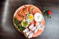 Boiled eggs with green onions, fried potato pancakes, bread with delicious bacon. Dish is decorated with fresh herbs and served Royalty Free Stock Photo