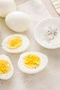 Boiled eggs peeled and cut in half with salt and pepper Royalty Free Stock Photo