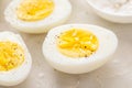 Boiled eggs peeled and cut in half with salt and pepper Royalty Free Stock Photo