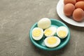 Boiled eggs in white ceramic plate on grey background Royalty Free Stock Photo