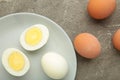 Boiled eggs in white ceramic plate on grey background Royalty Free Stock Photo
