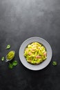 Boiled fettuccine pasta with fresh spinach pesto and shrimps on black background. Italian cuisine. Healthy dish for lunch Royalty Free Stock Photo