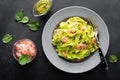 Boiled fettuccine pasta with fresh spinach pesto and shrimps on black background. Italian cuisine. Healthy dish for lunch Royalty Free Stock Photo