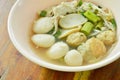 Boiled fish and shrimp ball topping slice pork in clear soup on bowl Royalty Free Stock Photo