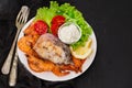 Boiled fish with shrimps and salad on white dish Royalty Free Stock Photo
