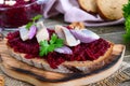 Boiled grated beets, pieces of herring, red onions, nuts on whole grain bread. Royalty Free Stock Photo