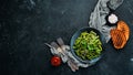 Boiled Green Asparagus Bean. In a black plate. Top view.