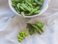 Boiled green soybeans on fabric backgroun