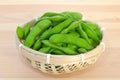 Boiled green soybeans in a small bamboo basket