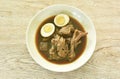 boiled half cut egg with braised duck meat and foot in Chinese herb brown soup on plate Royalty Free Stock Photo