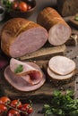 Boiled ham sliced on bread lie on a wooden board