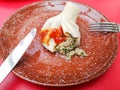 Boiled khinkali on a red table