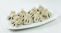 Boiled khinkalis Georgian dumpling on a white plate