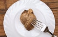 Boiled lamb heart on white plate on wooden background