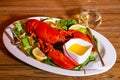 Boiled lobster and white wine feast. Royalty Free Stock Photo